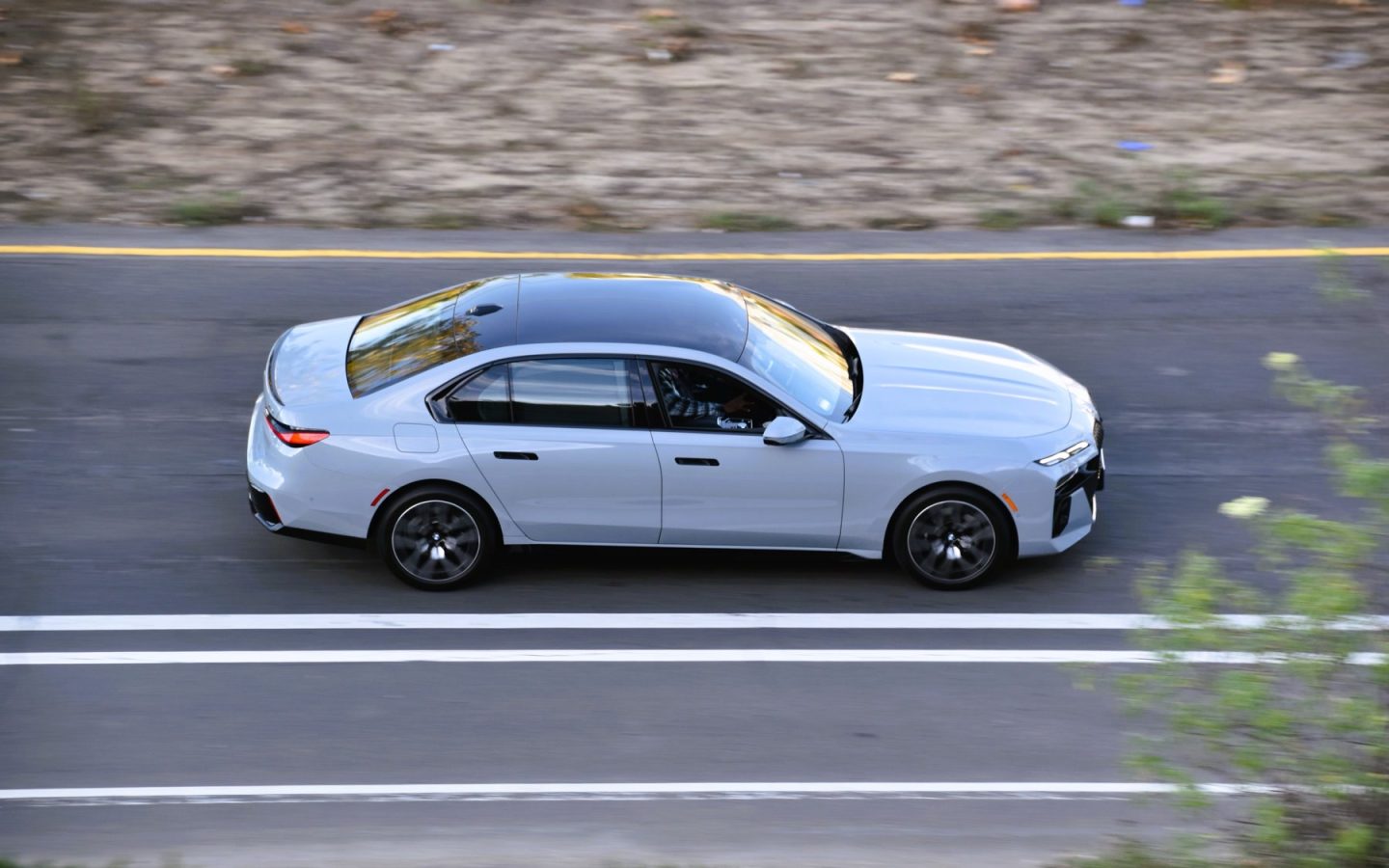 BMW Série 7 G70 blanche vue de profil en mouvement ; 740i étrangère non contractuelle