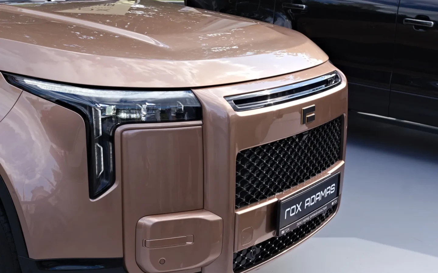ROX Adamas gris vu de trois quarts avant dans un salon automobile ; configuration étrangère non contractuelle